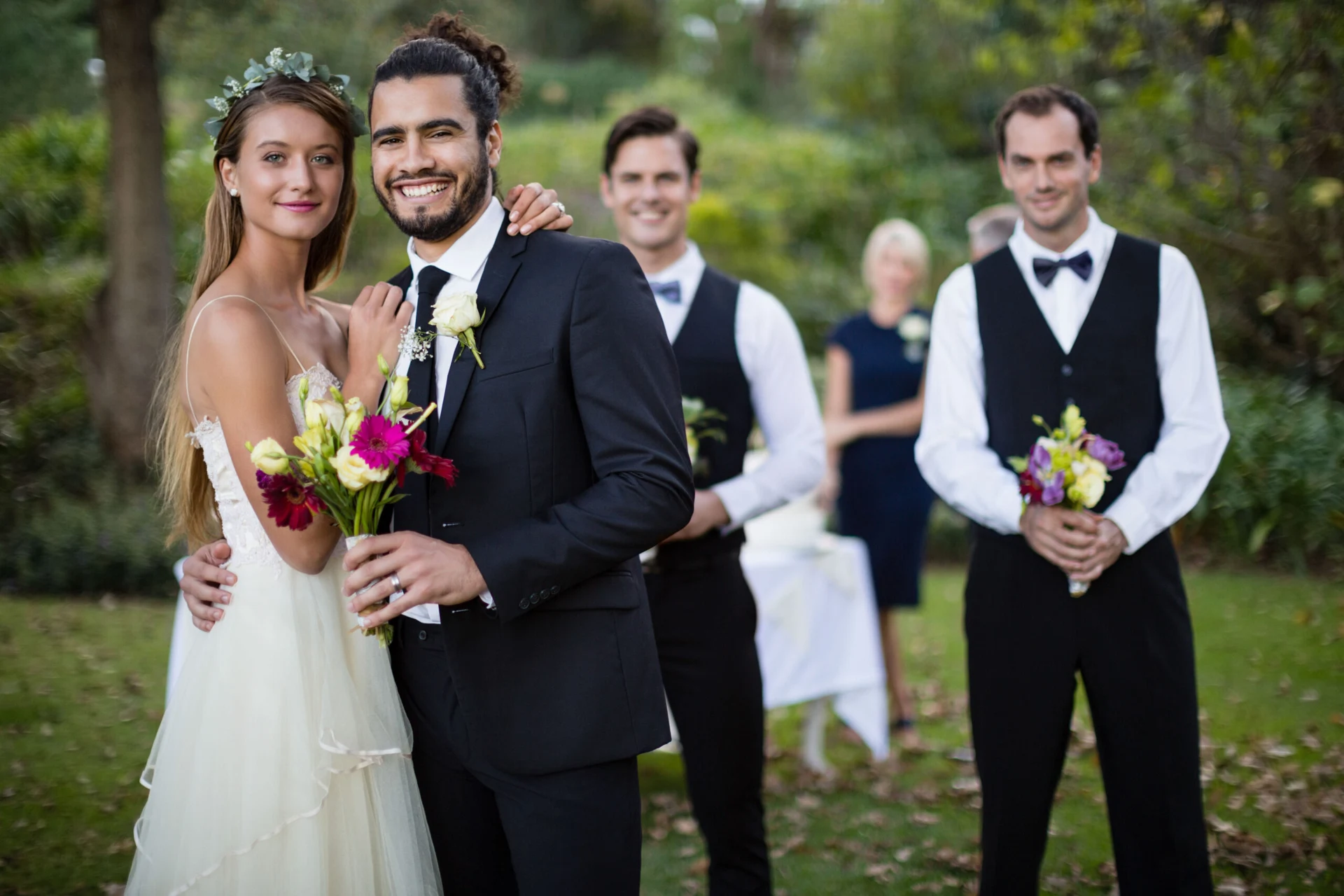 Bride and groom with their wedding party in a garden
