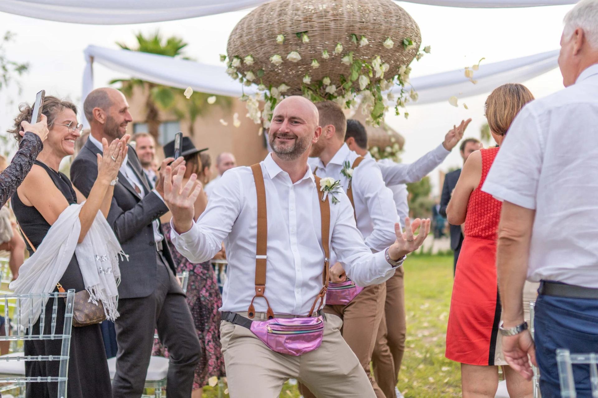 Groom dancing among celebrating guests