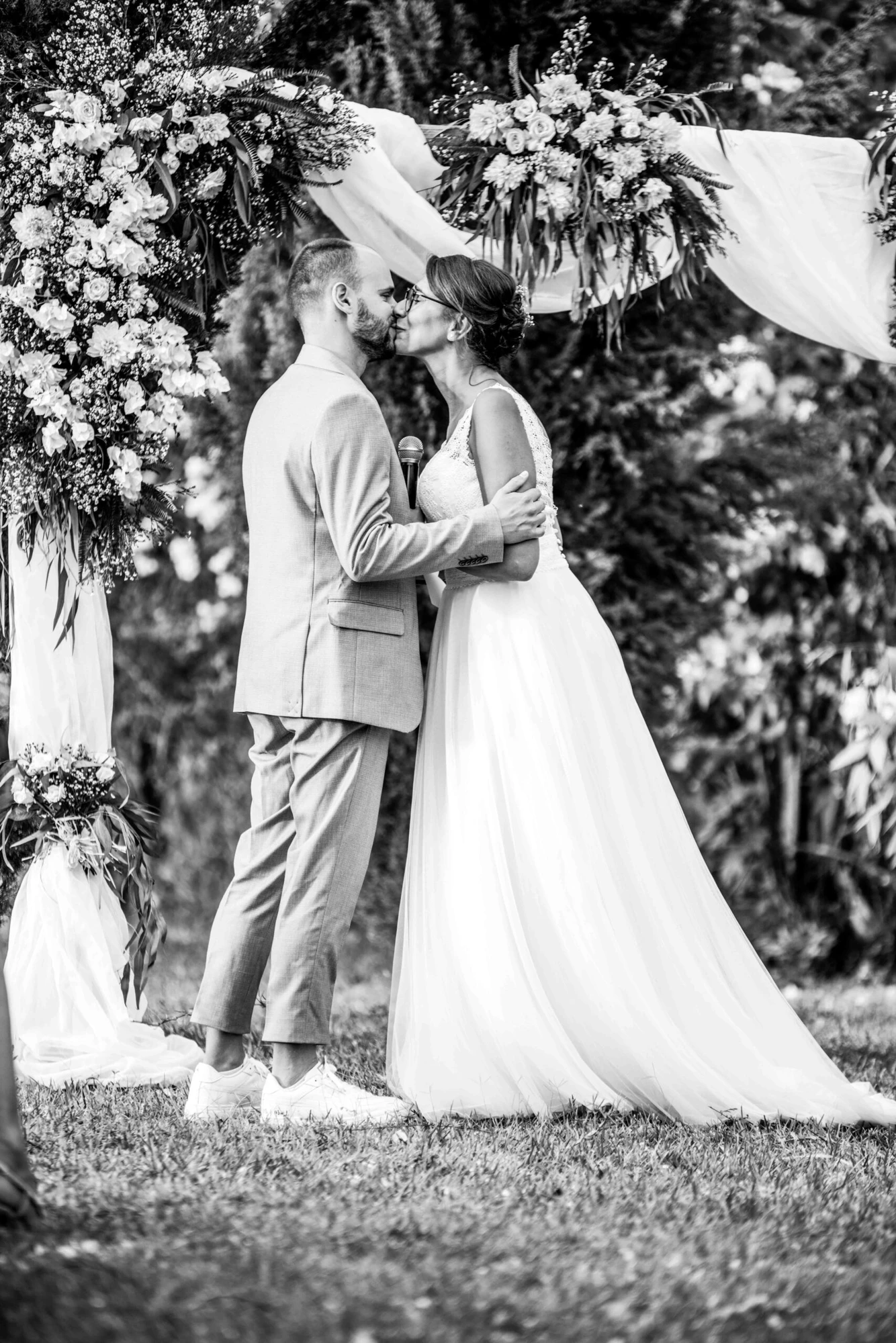 Newlyweds embracing in a quiet garden — original black-and-white edit